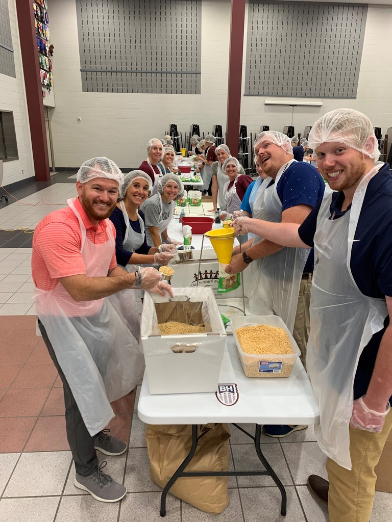 Packaging meals with the Outreach Program.
