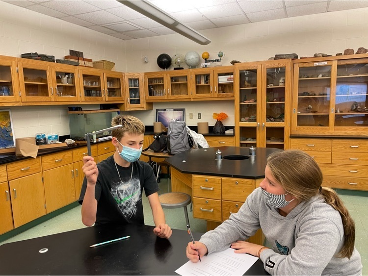 two students collaborate on an experiment.