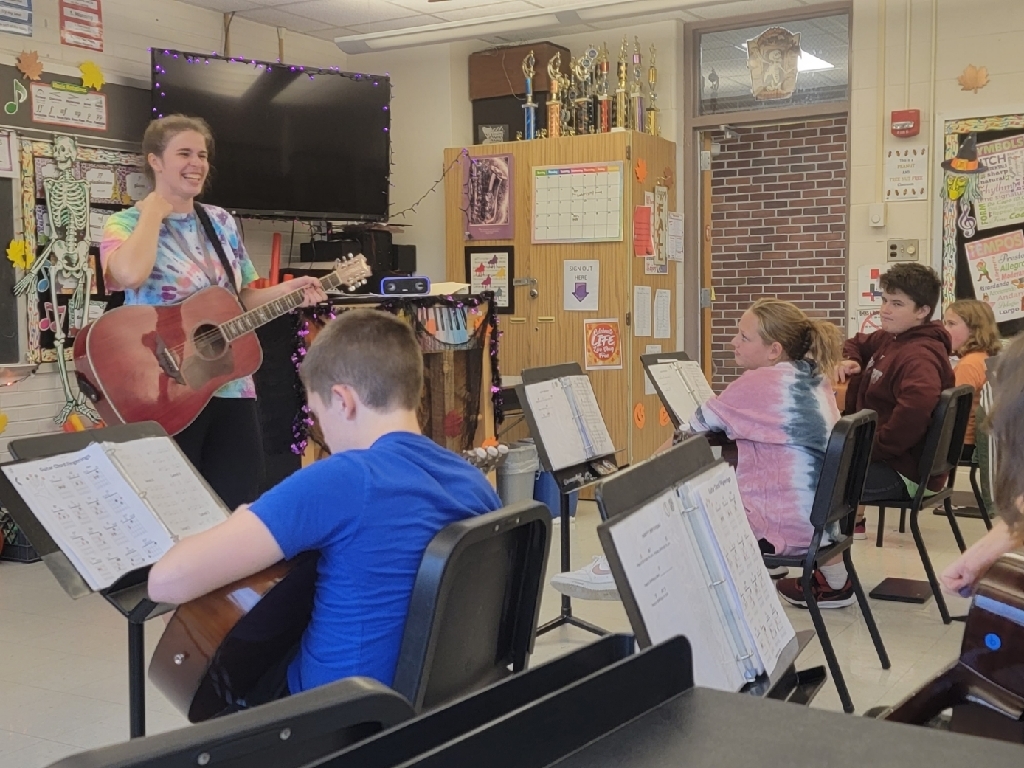 Mrs. O'Brian leading the class to play the classic song, Proud Mary