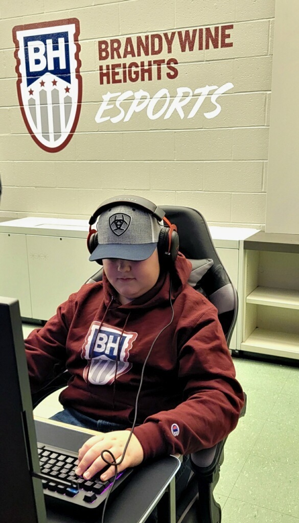 Student trying out to the esports lab equipment