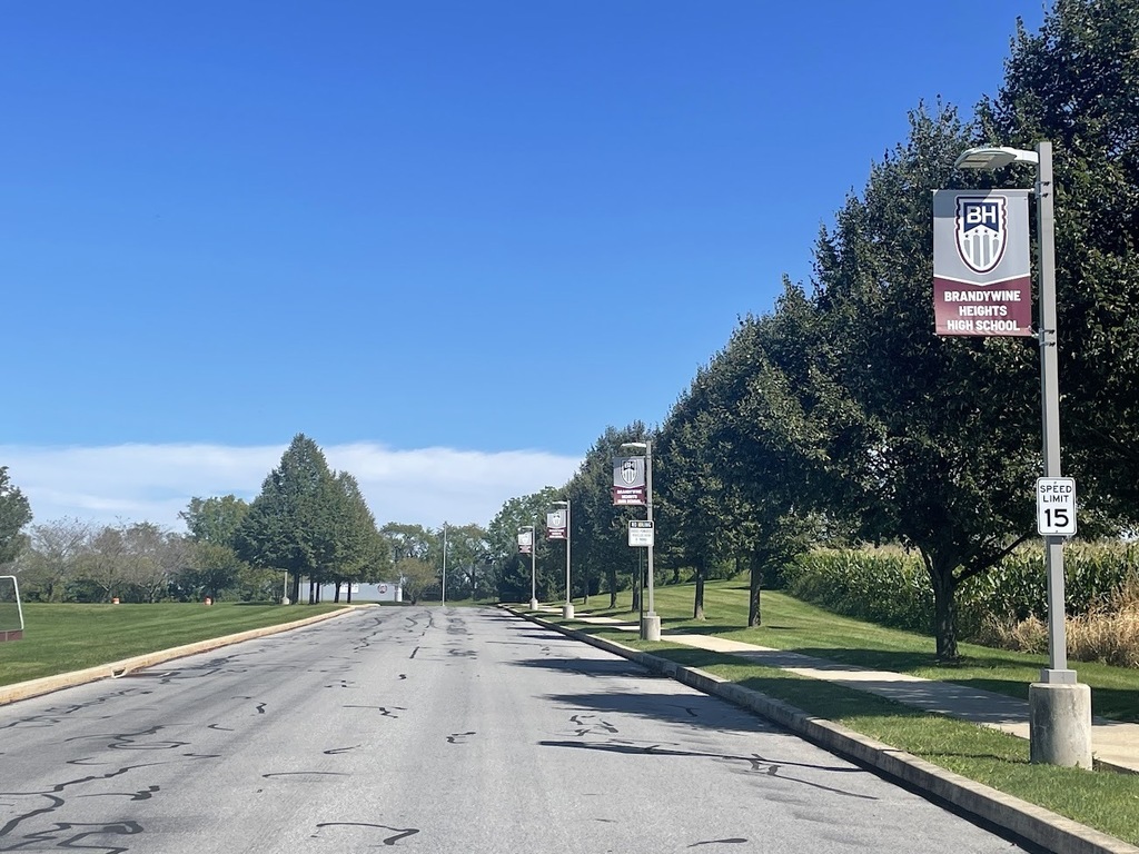 Avenue Banners line a driveway that say 'Brandywine Heights High School' 